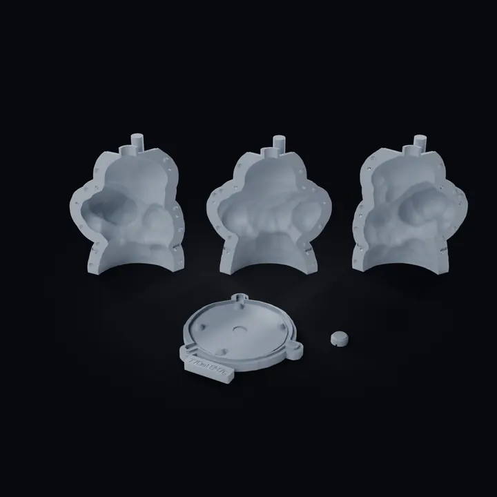 The five print files of the adaptive shell laid out as they print: three wedges standing on their feet, the base plate with its seat and the small threaded port plug